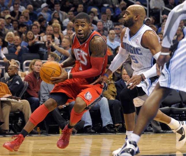 New Jersey Nets guard Terrence Williams, left, drives past Orlando Magic guard Vince Carter during the first half of an NBA basketball game in Orlando, Fla., on Nov. 5, 2010