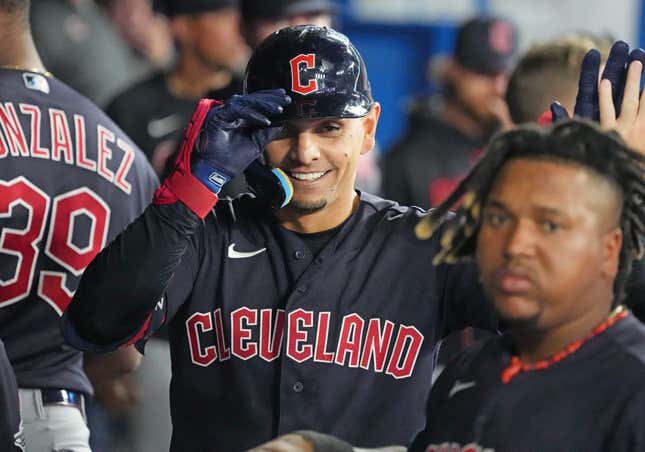 Aug 25, 2023; Toronto, Ontario, CAN; Cleveland Guardians second baseman Andres Gimenez (0) celebrates in the dugout after hitting a home run against the Toronto Blue Jays during the eighth inning at Rogers Centre.