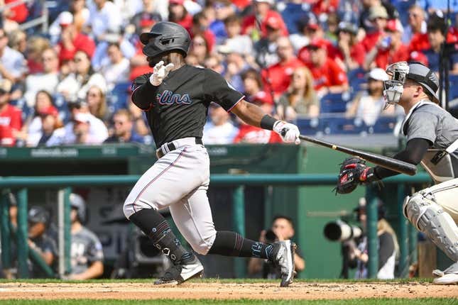 Jun 17, 2023; Washington, District of Columbia, USA; Miami Marlins center fielder Jonathan Davis (49) hits a RBI sacrifice fly against the Miami Marlins during the second inning at Nationals Park.