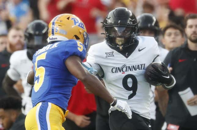 Sep 9, 2023; Pittsburgh, Pennsylvania, USA; Cincinnati Bearcats wide receiver Aaron Turner (9) carries the ball on an end around as Pittsburgh Panthers defensive back Phillip O&#39;Brien Jr. (5) chases during the first quarter at Acrisure Stadium.