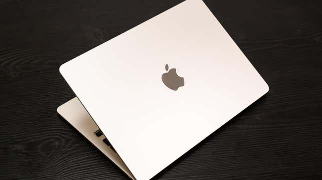 macbook air laptop open on wooden desk