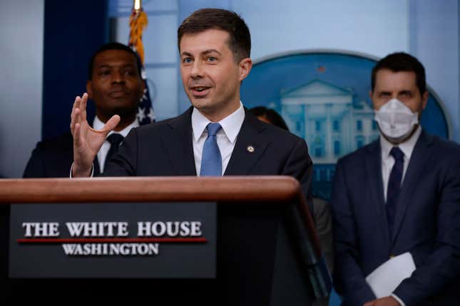  Transportation Secretary Pete Buttigieg (C) speaks during a news conference marking six months since the signing of the bipartisan infrastructure bill with Environmental Protection Agency Administrator Michael Regan (L) and National Economic Council Director Brian Deese in the Brady Press Briefing Room at the White House on May 16, 2022, in Washington, DC.