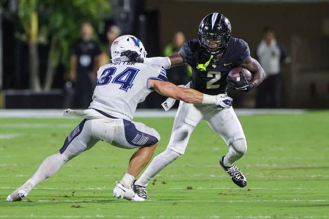 Sep 16, 2023; Orlando, Florida, USA; UCF Knights wide receiver Kobe Hudson (2) runs the ball as Villanova Wildcats defensive back Ethan Potter (34) moves in during the second quarter at FBC Mortgage Stadium.