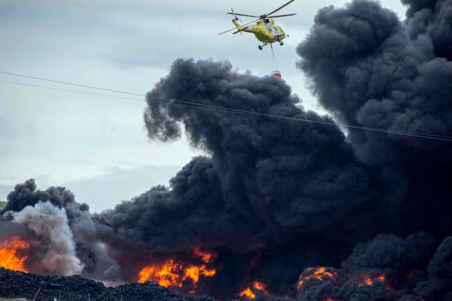 A helicopter tries to extinguish the flames at Sesena.