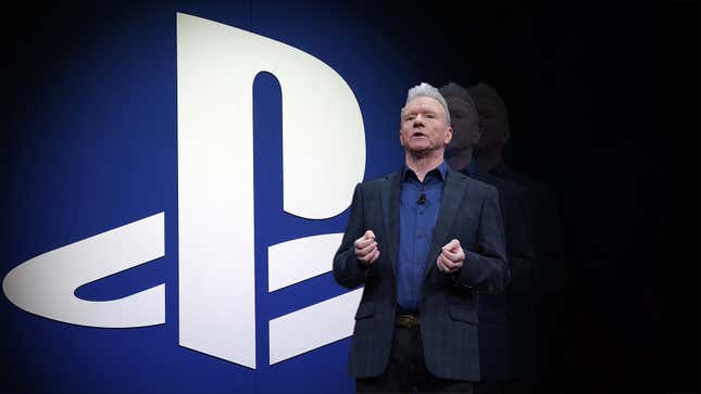 Jim Ryan stands in front of a PlayStation logo. 