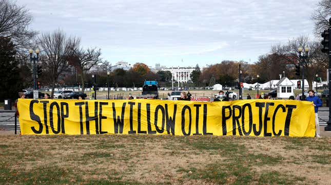 Students and community members demand President Biden stop the Willow Project by unfurling a banner on the Ellipse outside the White House on December 02, 2022 in Washington, DC. 