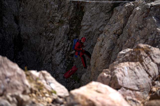 A European Cave Rescue Association (ECRA) member goes down into the Morca cave during a rescue operation near Anamur, south Turkey, Friday, Sept. 8, 2023. American researcher Mark Dickey, 40, who fell ill almost 1,000 meters (more than 3,000 feet) below the entrance of a cave in Turkey, has recovered sufficiently enough to be extracted in an operation that could last three or four days, a Turkish official was quoted as saying on Friday. (AP Photo/Khalil Hamra)