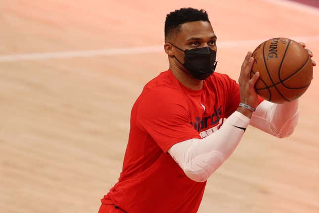 Russell Westbrook shoots around in a face mask.