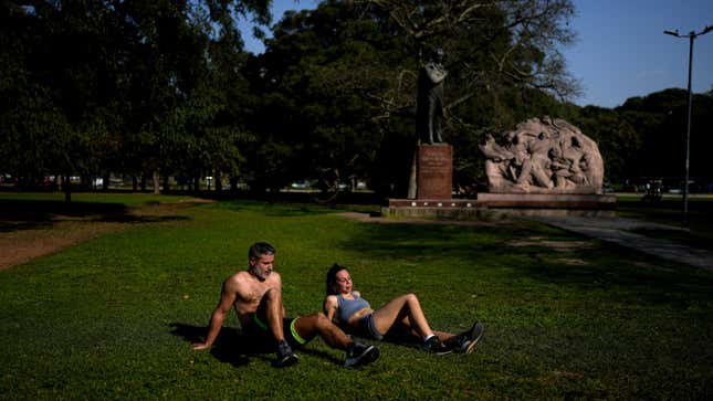 A man and a woman sunbathe at a park in Buenos Aires, Argentina, on Aug. 2, 2023 as the country’s capital breaks a record for hottest start to August in 117 years.