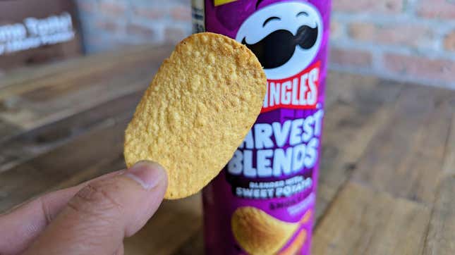 hand holding Pringles Harvest Blends Smoky BBQ chip