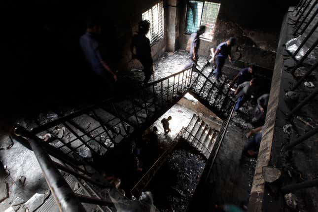 Members of the police inspect a garment factory after a devastating fire in Savar November 25, 2012. A fire swept through Tazreen Fashion factory in the Ashulia industrial belt of Dhaka, on the outskirts of Bangladesh's capital killing more than 100 people, the fire brigade said on Sunday, in the country's worst ever factory blaze.