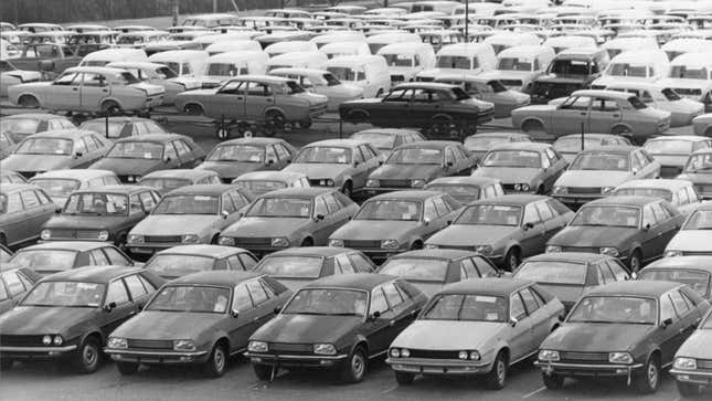 A photo of a factory full of abandoned British Leyland Cars. 