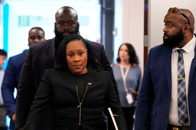 Fulton County District Attorney Fani Willis, center, arrives to the Fulton county courthouse, Tuesday, July 11, 2023, in Atlanta. A grand jury being seated Tuesday in Atlanta will likely consider whether criminal charges are appropriate for former President Donald Trump or his Republican allies for their efforts to overturn his 2020 election loss in Georgia. 