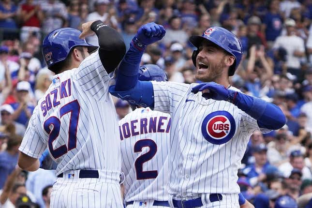 Jul 15, 2023; Chicago, Illinois, USA; Chicago Cubs center fielder Cody Bellinger (24) is greeted by right fielder Seiya Suzuki (27) after hitting a grand slam home run against the Boston Red Sox during the third inning at Wrigley Field.
