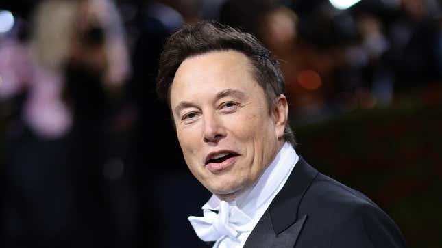 An image of Elon Musk laughing and looking at the camera at the 2022 Met Gala.