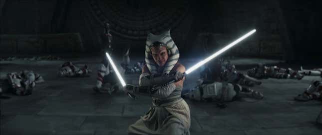 Ahsoka stands with her lightsabers crossed, a pile of downed shadow troopers behind her.