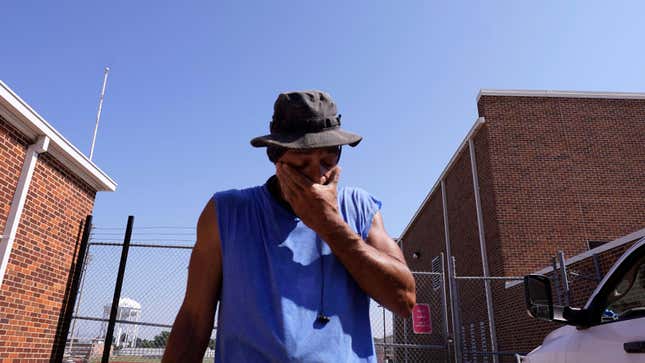 Fence installer Michael Gillespie takes a break to wipe his face while working in the heat in Richardson, Texas on July 24, 2023.