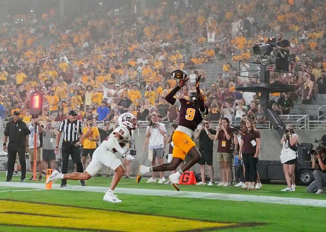 Aug 31, 2023; Tempe, Arizona, USA; Arizona State Sun Devils wide receiver Troy Omeire (9) makes a touchdown catch over Southern Utah Thunderbirds cornerback Jehvonn Lewis (26) during a dust storm in the first half at Mountain America Stadium.