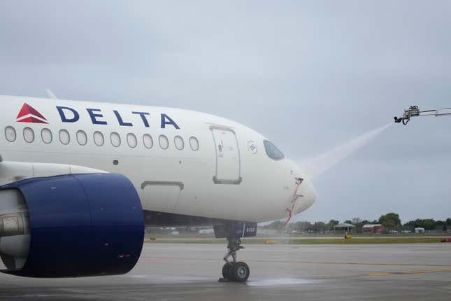 An Airbus A220 is sprayed as part of deicing training for Delta Air Lines employees in preparation for winter weather at Minneapolis-St. Paul airport, Wednesday, Sept. 6, 2023, in Minneapolis. (AP Photo/Abbie Parr)