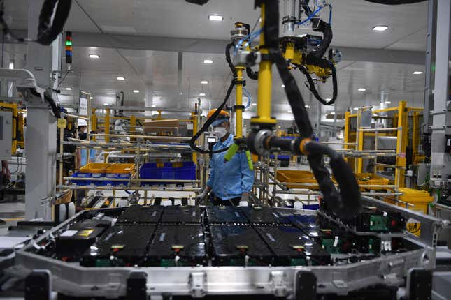 A worker assembles an electric car battery inside the battery pack shop at the electric automobile plant of VinFast in Haiphong on April 7, 2022. 