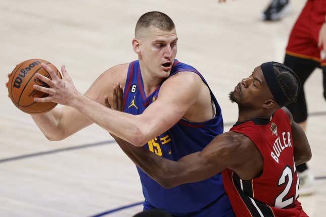 Jun 1, 2023; Denver, CO, USA; Denver Nuggets center Nikola Jokic (15) controls the ball while defended by Miami Heat forward Jimmy Butler (22) during the second quarter in game one of the 2023 NBA Finals at Ball Arena.