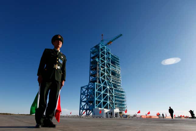 A soldier stood guard beside the Long March-2F rocket, loaded with China’s unmanned space module Tiangong-1, the day before its launch.