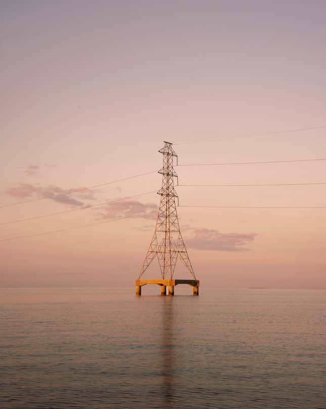 Power lines and a tower sitting in the middle of water near Kenner, Louisiana.
