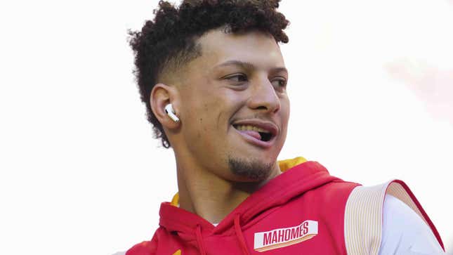 Patrick Mahomes sticks his tongue out through his teeth during practice.