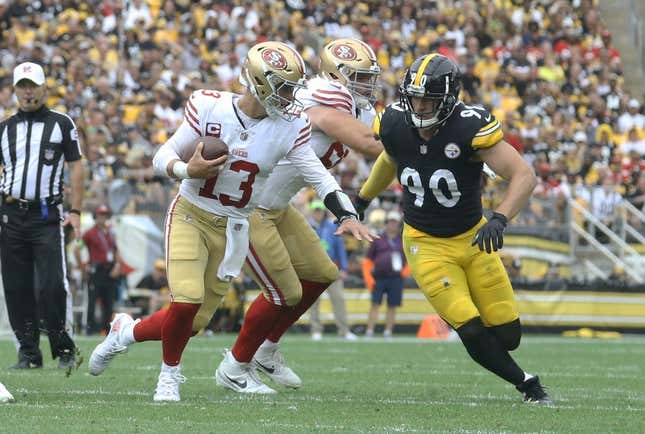 Sep 10, 2023; Pittsburgh, Pennsylvania, USA;  San Francisco 49ers quarterback Brock Purdy (13) scrambles with the ball as Pittsburgh Steelers linebacker T.J. Watt (90) chases during the second quarter at Acrisure Stadium.