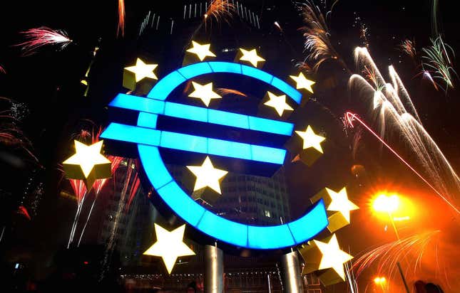 Fireworks illuminate the sky around a huge euro sculpture, designed by German artist Ottmar Hoerl, in front of the headquarters of the European Central Bank (ECB) in Frankfurt, January 1, 2002. Several thousand people in Frankfurt celebrated at a party on the streets around the ECB to welcome Europe's new currency, the euro. UNICS REUTERS/Kai Pfaffenbach REUTERS KP - RTRBPKK