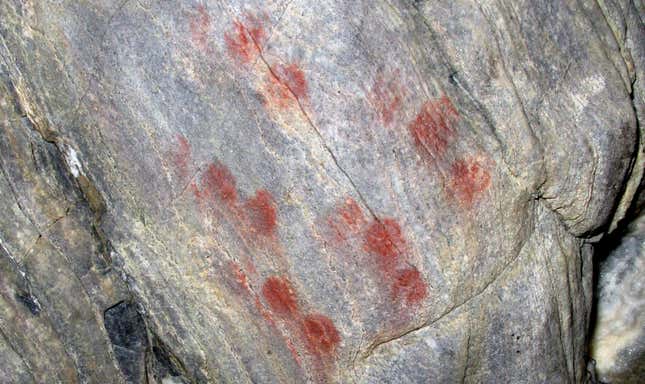 Red dots on the cave wall.