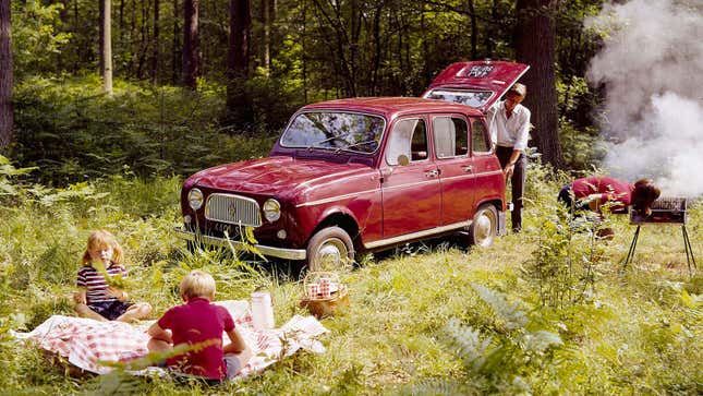 A photo of a red Renault 4 hatchback in a forrest. 