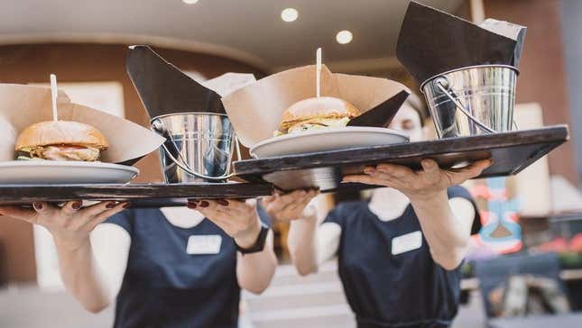 Servers carrying tray of food