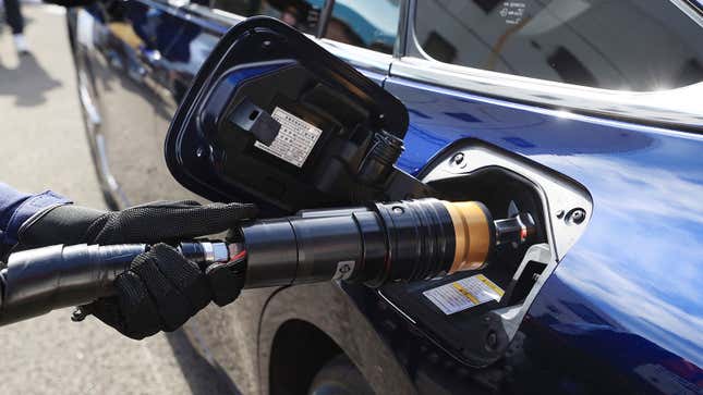 A person fills up a hydrogen fuel-cell vehicle in Japan.