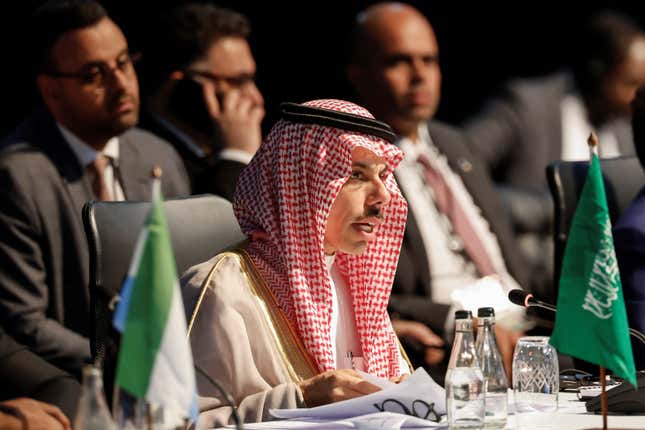 Saudi Arabia's foreign minister Faisal bin Farhan Al Saud sits at a table and speaks at the BRICS summit.