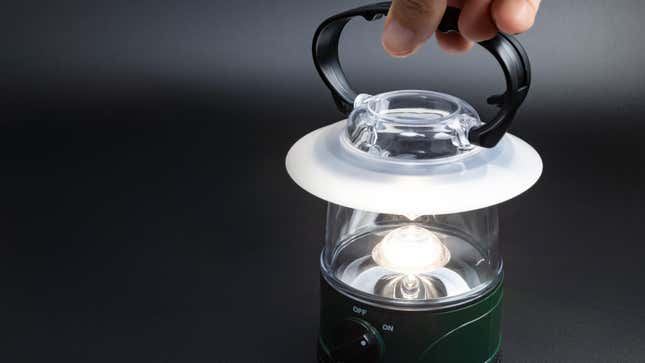 A hand holding an LED lantern