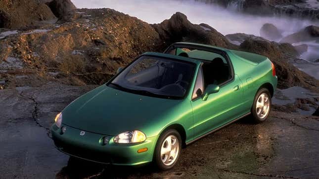 A photo of a green Honda Del Sol convertible. 