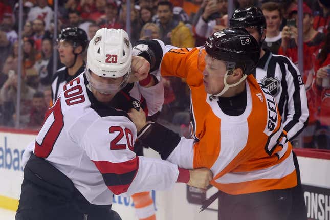 Feb 25, 2023; Newark, New Jersey, USA; New Jersey Devils center Michael McLeod (20) and Philadelphia Flyers defenseman Nick Seeler (24) fight during the second period at Prudential Center.
