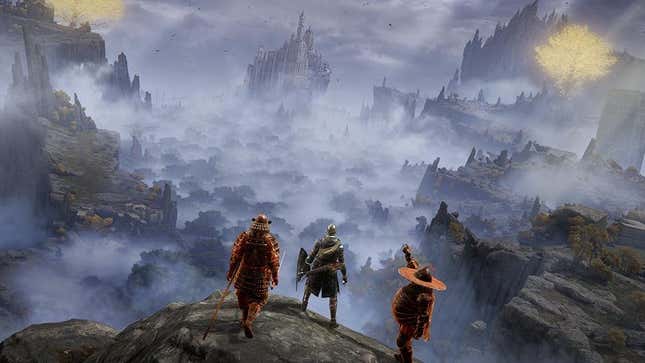 Three Elden Ring warriors stand on a cliff overlooking a foggy valley that leads to a castle.