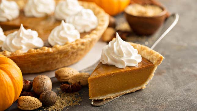 Pumpkin pie with whipped cream dolloped on top. 