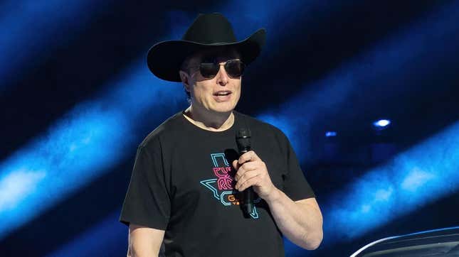 Elon Musk speaks at a Tesla factory, wearing sunglasses indoors for some unknown reason, on April 7, 2022 in Austin, Texas.