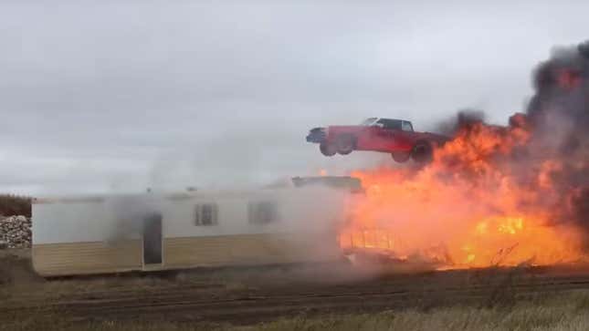 Stunt driver the Flying Farmer jumps over a burning caravan