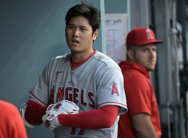 Jul 8, 2023; Los Angeles, California, USA; Los Angeles Angels designated hitter Shohei Ohtani (17) and center fielder Mike Trout (27) look on from the dugout during the game against the Los Angeles Dodgers at Dodger Stadium.