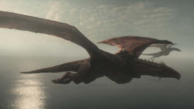Two dragons soar majestically above a sun-dappled ocean. 