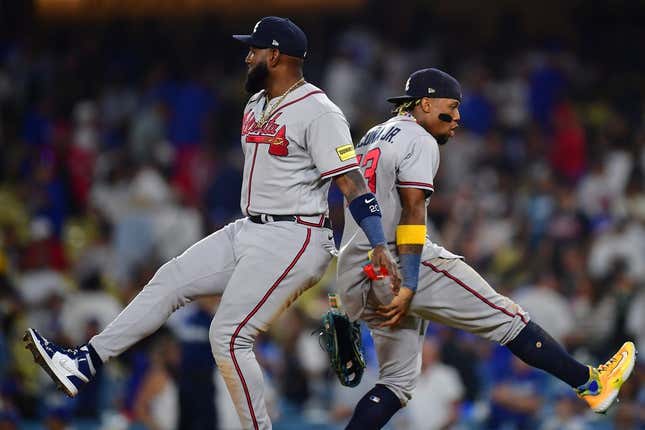 September 1, 2023; Los Angeles, California, USA; Atlanta Braves designated hitter Marcell Ozuna (20) and right fielder Ronald Acuna Jr. (13) celebrate the victory against the Los Angeles Dodgers at Dodger Stadium.