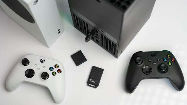 A Western Digital Xbox Series X/S expansion card sits next to the consoles and controllers. 