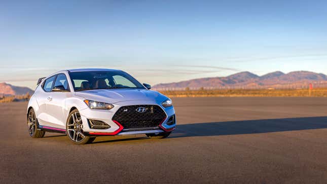 A photo of a Hyundai Veloster N parked on a runway. 