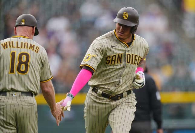Jun 9, 2023; Denver, Colorado, USA; San Diego Padres third baseman Manny Machado (13) celebrates his two-run home run with San Diego Padres third base coach Matt Williams (18) in the first inning against the Colorado Rockies at Coors Field.