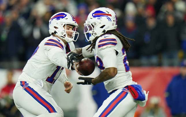 Dec 1, 2022; Foxborough, Massachusetts, USA; Buffalo Bills quarterback Josh Allen (17) hands off the ball to running back James Cook (28) against the New England Patriots in the first quarter at Gillette Stadium.
