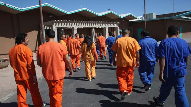 Immigrant detainees walk through the Immigration and Customs Enforcement (ICE), detention facility on February 28, 2013 in Florence, Arizon